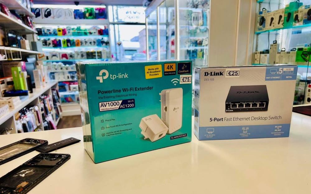 Networking and Wi-Fi products on the counter at Dungarvan Tech with a phone being repaired