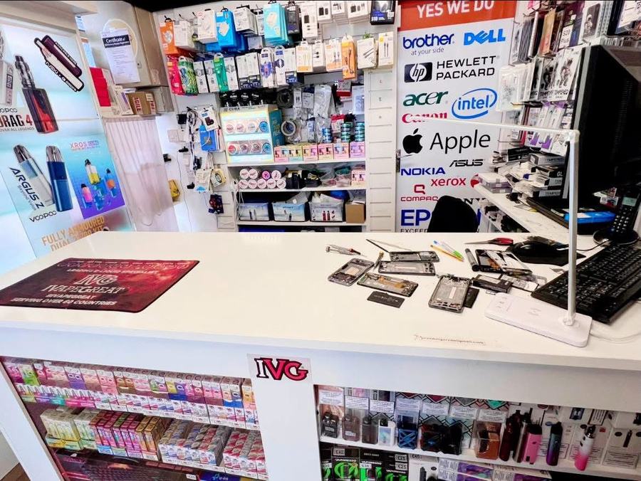 Phone repair bench at Dungarvan Tech with devices being repaired